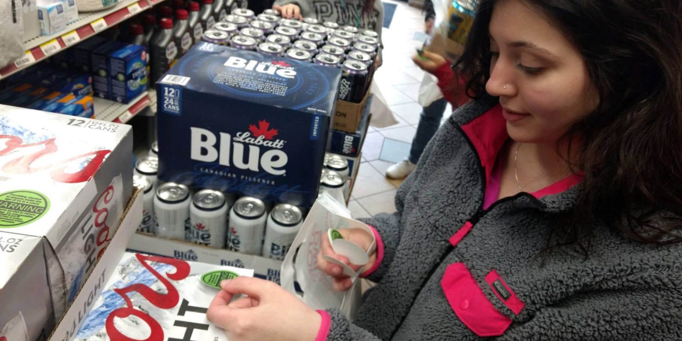 Project Sticker Shock putting stickers on alcohol for sale