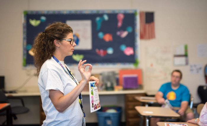 Teacher instructing students at the Villa of Hope